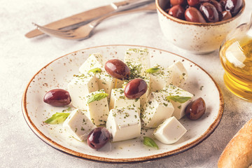 Greek cheese feta with oregano and olives.