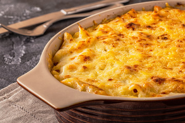 Mac and cheese, american style macaroni pasta in cheesy sauce.