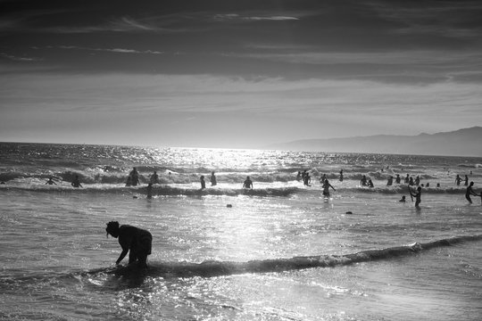 A black and white photo of the sunsetting in Santa Monica Beach, Santa Monica, California