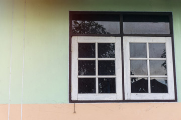 Cement wall and wooden window of the old house., thai style