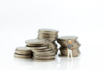Miniature people: Financial people standing on coins. Image use for business accounting concept, check the amount or profit from investment.