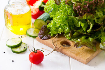 Ingredients cooking for summer salad on a white kitchen table. The concept of nutrition health.