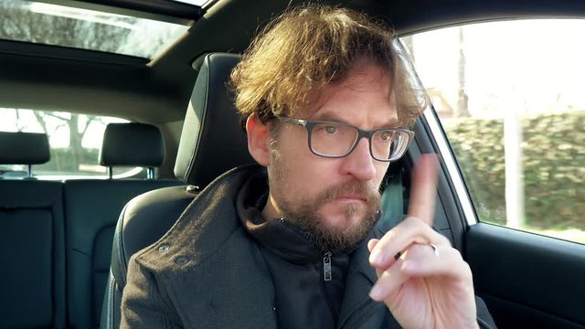 Man in car thinking having doubts driving
