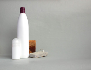 Body care products on grey background, copy space