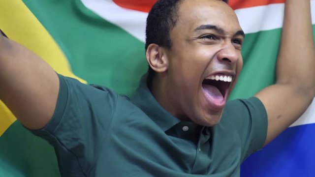 South African Fan celebrating while holding the flag of South Africa in Slow Motion