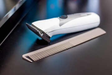 Comb and a haircut machine in  barbershop on  master's table_