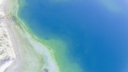 Top view aerial photo from flying drone of a beautiful sea landscape with amazing blue and green water 