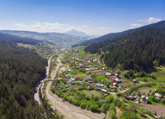 aerial view of village and forest, panorama from Poiana Teiului. Romania
