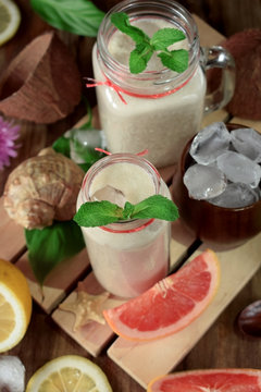 Coconut cocktail decorated with mint in glass jars. Top view
