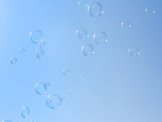 Soap bubbles, Blowing soap bubble on Blue sky background