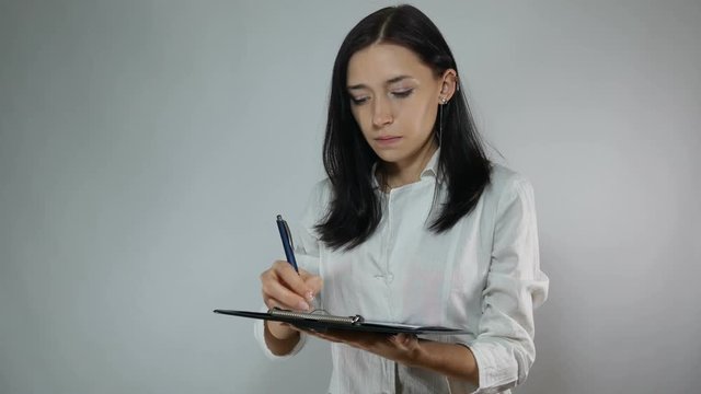 young woman doctor writes