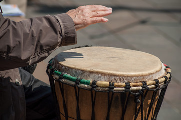 Fototapeta na wymiar closeup of woman hand on african drums in outdoor