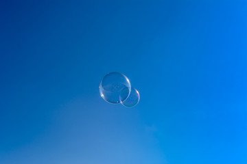 Soap bubbles, Blowing soap bubble on Blue sky background