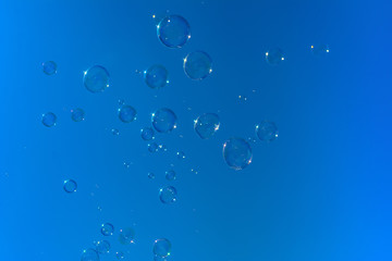 Soap bubbles, Blowing soap bubble on Blue sky background