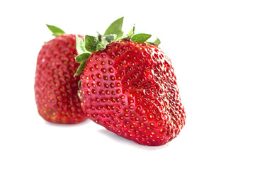 two ripe juicy textured red strawberries