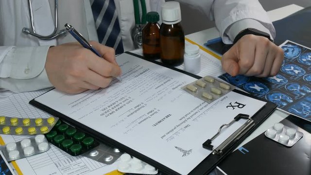 doctor writes out tablets