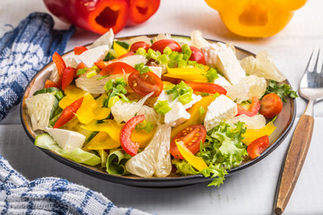 Salad with cheese and fresh vegetables.