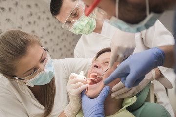 three doctors doing check up at the dentist office - oral hygiene health care concept