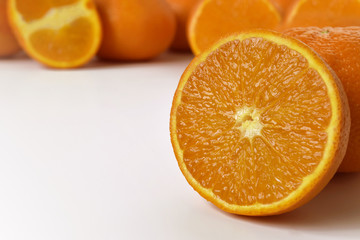 natural oranges in the foreground, macro shot with a reflection, free space for text on a white background