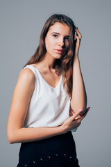 Naklejka premium Fashionable young woman female model isolated on gray background