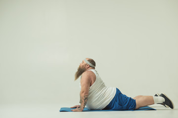 Man lying on a yoga mat exercising