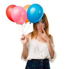 Sad beautiful young girl holding a balloon