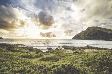 Hawaiian beach with crashing waves and a sunset