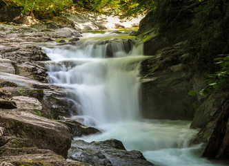 Fototapeta na wymiar waterfall with long exposure and rocky mountain