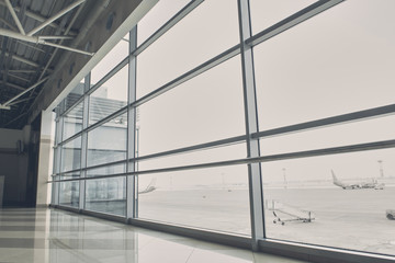 Close up wide window of modern airport hall. Different planes locating on street