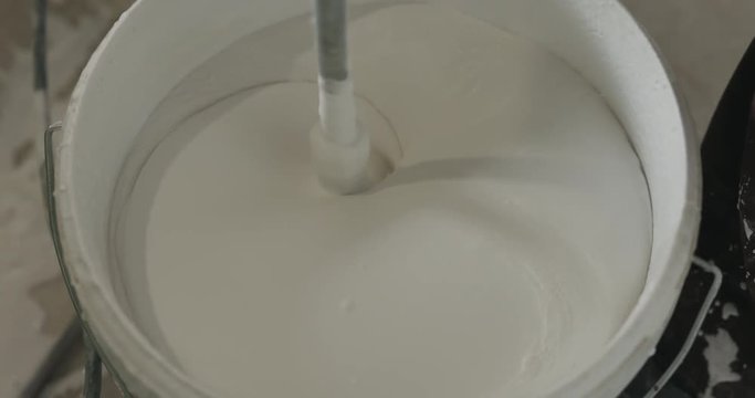 slow motion stirring putty in the bucket