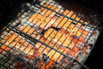 Grilled steaks a on open grill on back yard