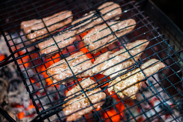 Grilled steaks a on open grill on back yard