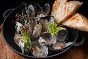 Mussels with sour cream sauce. Seafood. Shellfish in shells. Delicious appetizer for gourmets.