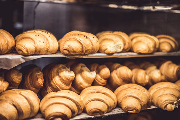 Fresh baked croissants on a showcase in a bakery shop