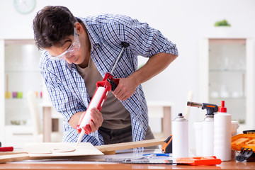 Young man in woodworking hobby concept