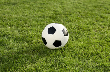 Fototapeta na wymiar Soccer / football ball on green grass top view 