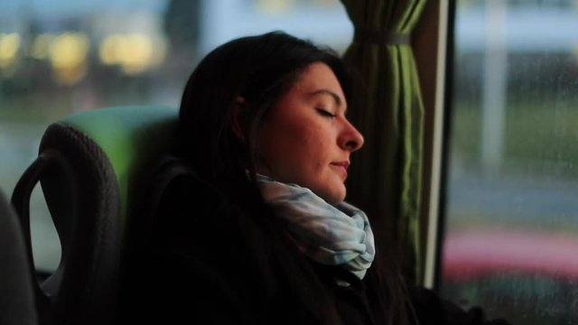 Passenger asleep while traveling by bus. Girl sleeping while riding onibus