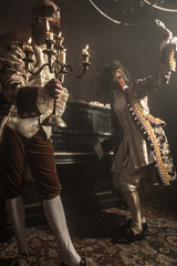 Actors in Steam punk masks and antique costumes indoor.