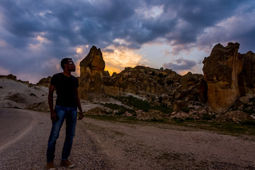 Young black man posing in front of Frig ruins