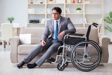 Dsabled businessman on wheelchair working home