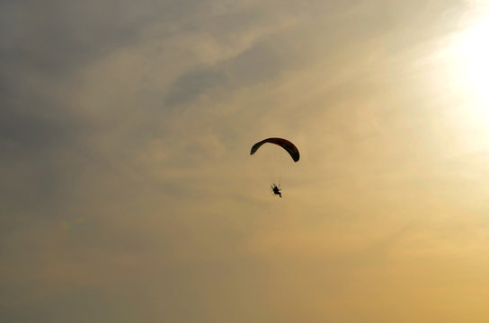 motoparaplane against the sky and the sun..  Above the Mediterranean Sea, Israel.. Extreme sports, enjoy life, value the moment,.Fly towards the sun