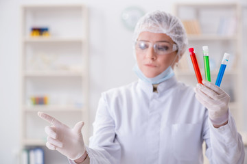 Woman chemist pressing virtual button in lab