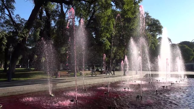 Wine fountain with rainbow. The fountains are tinted pink to look like giant pools of inviting red, Plaza de Independence of Mendoza, the city of wine, Argentina , 4K