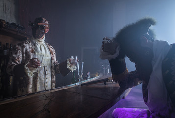 Actors in Steam punk masks and antique costumes indoor.