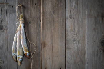 dried fish on wooden boards