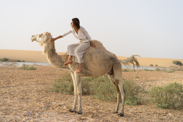 Camel riding in oasis
