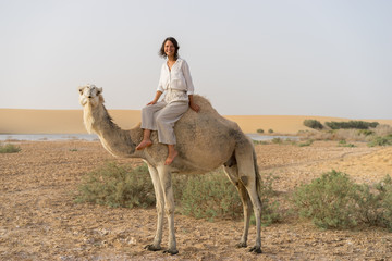Camel riding in oasis
