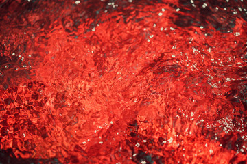 Autumnal red blurry abstract water background. Formed from sunny reflections of forest trees and movement in a river. With copy space for your text, Wallpaper, Backdrop, Water fall, Nature.