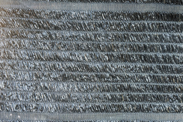 Black shading net textured for background.