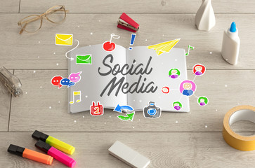 Notebook on the floor with instruments on the floor and social media, internet label on it